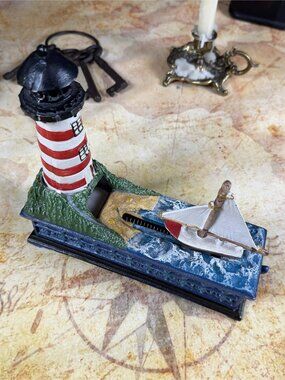 Cast Iron Lighthouse & Sailboat Mechanical Coin Bank